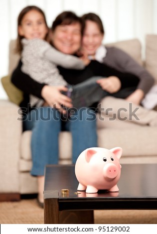 family saving money on a piggy bank