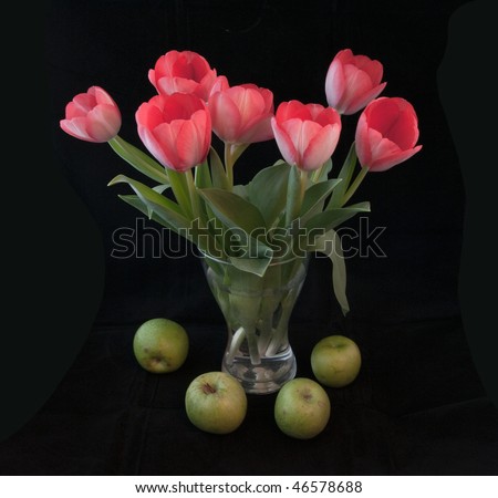 Bouquet of tulips with green apples on a black background