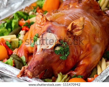 Decorated and roast pig on a platter