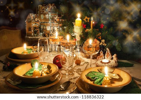 Christmas dinner table with candles with christmas atmosphere