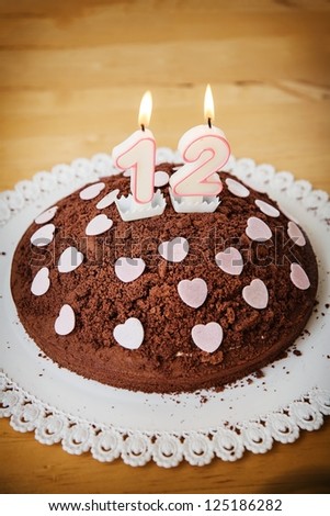 Birthday-anniversary cake with candles showing Nr. 12