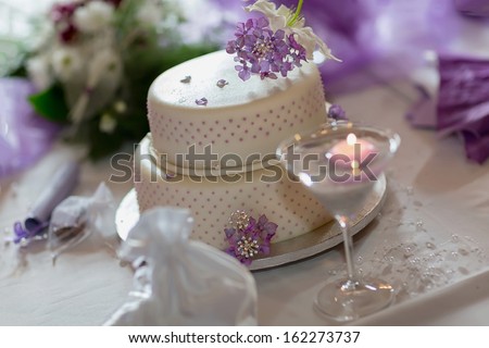 Traditional wedding cake with purple flowers