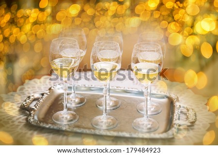 Six champagne flutes on gold shiny background