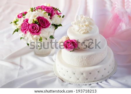 Traditional wedding cake and bridal bouquet