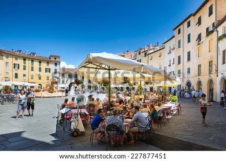 LUCCA, Italy 30 June 2014 people sitting outside at the restaurant on of Piazza Dell Anfiteatro, 30 June 2014 Lucca, Tuscany, Italy, Editorial for only