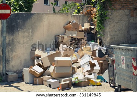 Garbage dumpsters cardboard boxes full of trash