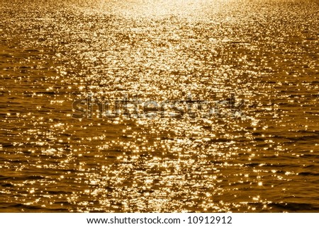 Evening look on of gold waved water surface