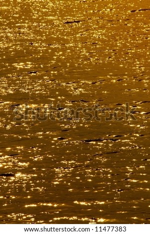 Evening look on of gold waved water surface