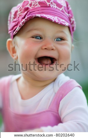Portrait of a little cute laughing girl - very small focus