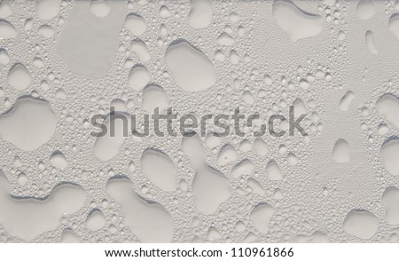The drops of water on the white painted surface