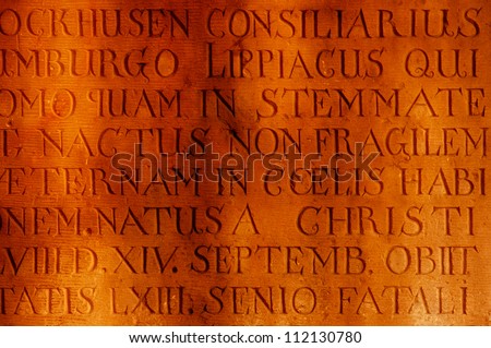 Ancient inscription in Latin carved in stone on the wall of the church in Germany