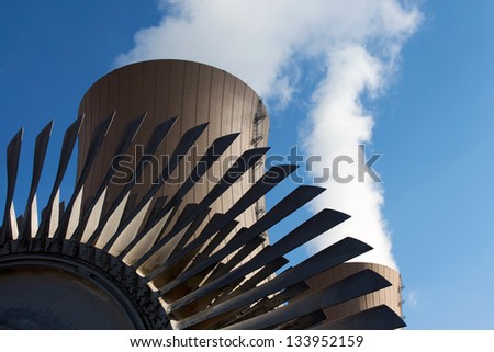 Steam turbine against nuclear power plant. Conceptual image of nuclear energy