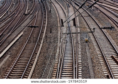 Railroad crossing on gravel in the sunlight