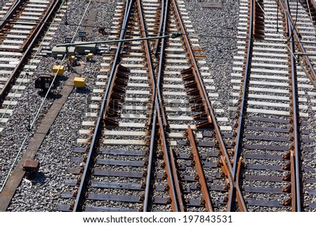 Railroad crossing on gravel in the sunlight