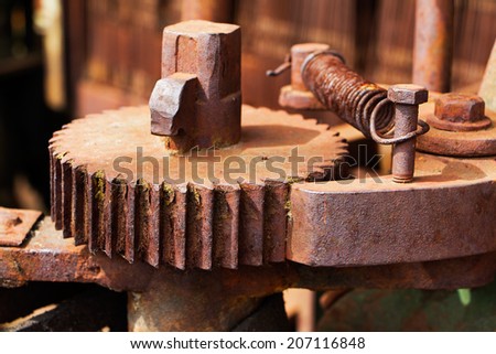Old and rusty pinion gear of a machine in factory