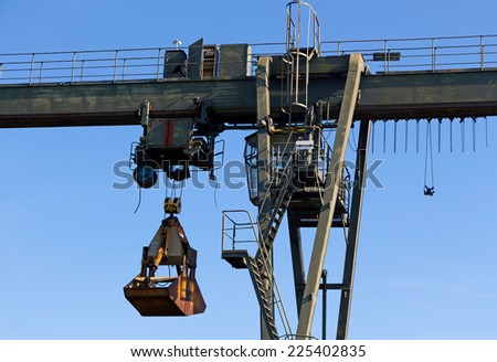 The gantry crane against a blue sky