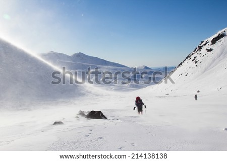 hiker is fighting with ice wind