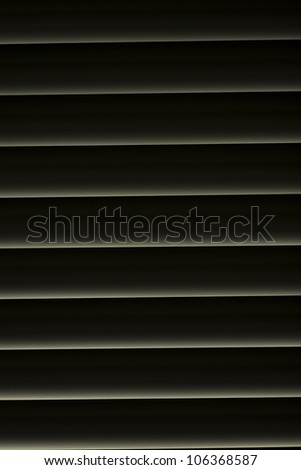 Window with dark Venetian Blinds that are shut