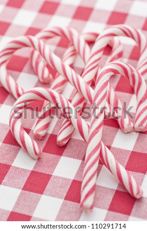Heap of Candy Canes on red and white linen
