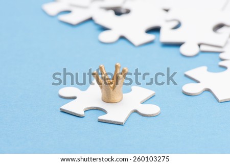 Golden crown on puzzle piece. Conceptual image of connection, solution and business strategy.