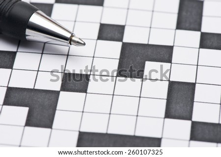 Closeup of blank crossword puzzle and pen. Conceptual image of problem solving, finding solutions and intelligence.