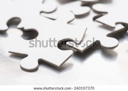 Close up of white puzzle pieces. Conceptual image of connection, solution and business strategy.