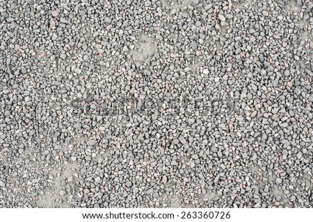 Backdrop of an gravel lying on the ground. This empty surface is perfect as copy space or textured background.