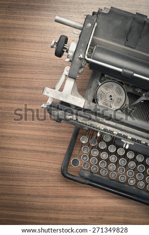 Retro vintage typewriter on wooden table. Conceptual image of old fashioned office work, communication or writing.
