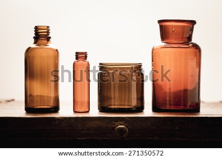 Old fashioned brown glass bottles. Conceptual image of historical clinical testing, scientific analysis and retro science.