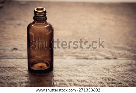 Old fashioned brown glass bottle. Conceptual image of historical clinical testing, scientific analysis and retro science.