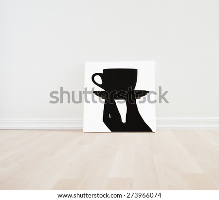 Empty room interior with artwork picture frame standing on wooden floor. Bright white scandinavian design and clean contemporary architecture. The room works as backdrop for a coffee shop.