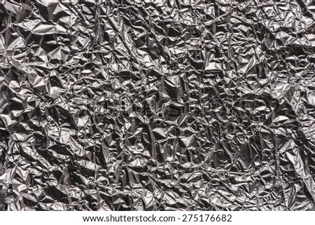 Crumpled aluminium foil texture. Empty background of wrinkled metal surface