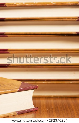 Close-up of pile with old vintage books. Hardcover leather literature.