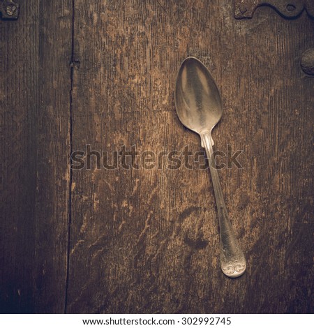 Close up of retro cutlery on rustic wooden background.  Conceptual image of cooking, eating food and kitchen objects.