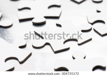Close up of white puzzle pieces. Conceptual image of connection, solution and business strategy.