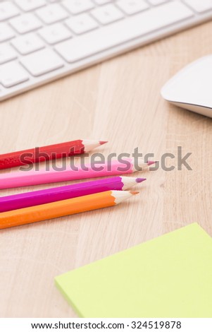 Colored pencils on workplace desktop. Concept of design and creativity at work.