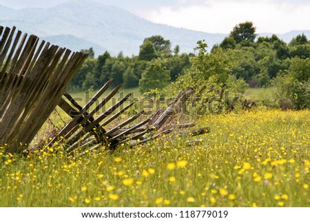 Wooden fences broken down in the grass