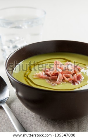 bowl of vegetable soup with ham and olive oil