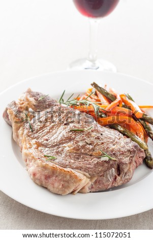 roasted beef steak with fried vegetables and wine