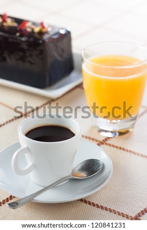 Breakfast with coffee, orange juice and chocolate plumcake