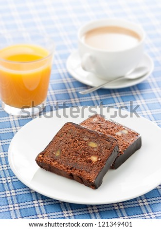 Delicious breakfast with coffee, orange juice and chocolate cake