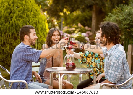 Group Of Friends Having A Toast With Sangria On A Bar Terrace