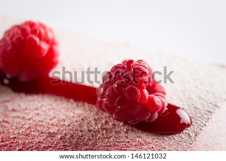 Detail of a raspberry in a red fruits mousse close-up