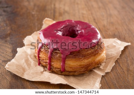 Red fruits fondant croissant and donut mixture on wooden table
