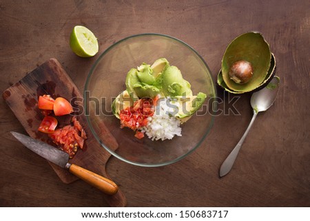 Preparing homemade guacamole on wooden table overview