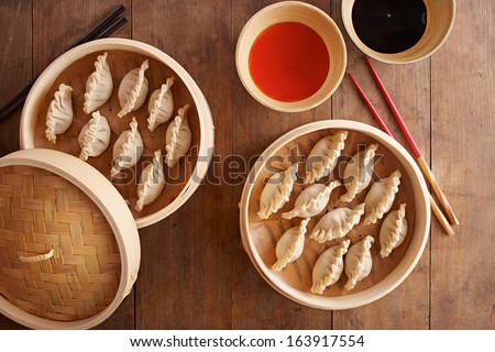 Homemade dim-sum asian dumplings on a traditional bamboo steamer