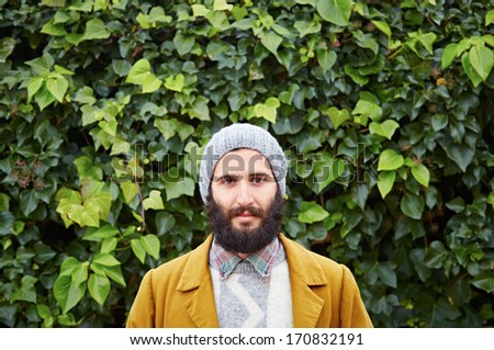 Smiling hipster bearded male student in vintage clothes