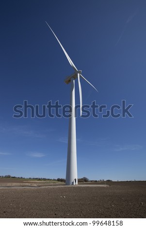 Human at the base of two megawatt (MW) wind turbine (80 meter rotor span, nacelle height 59.9 meters, max height 99.9 meters), Denmark