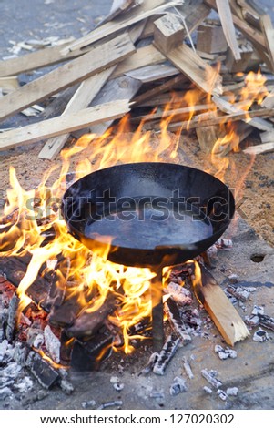 pan with sunflower oil on the fire in a wood fire