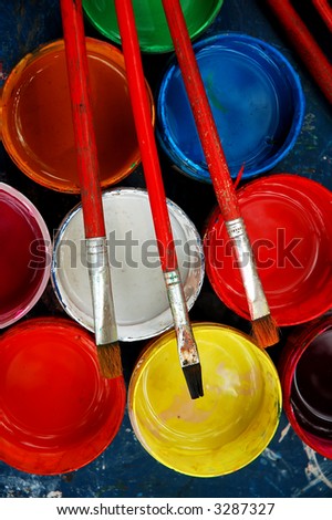 Paint and brushes on the blue desk